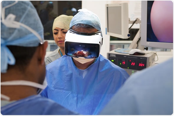 Surgeon wearing VR headset in an operating environment