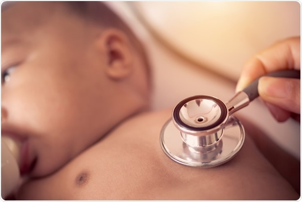 Pediatric doctor exams newborn baby girl with stethoscope in hospital. Image Copyright: WeStudio / Shutterstock