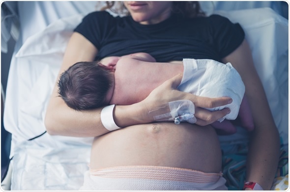 Breastfeeding her newborn child in the hospital