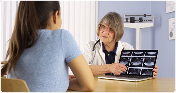 Senior doctor reviewing woman