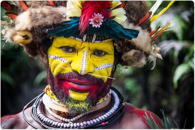 Male Huli tribe member in Tari area of Papua New Guinea in traditional clothes and face paint. Image Credit: By Amy Nichole Harris / Shutterstock