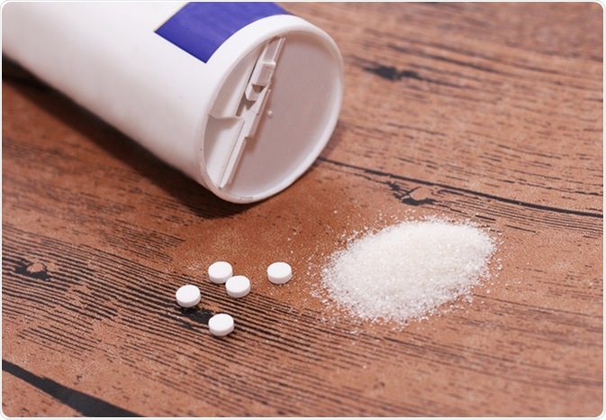 Sweetener tablet and sugar. Image Credit: SabOlga / Shutterstock