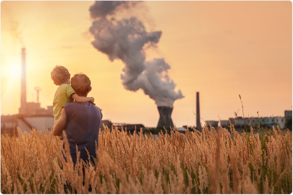 Man and his son, watching as factory pollutes the air - Global Warming Concept By Soloviova Liudmyla