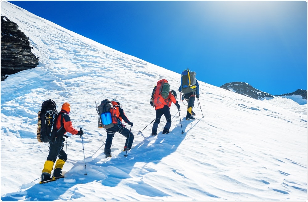 Women climbing to the summit of mountain