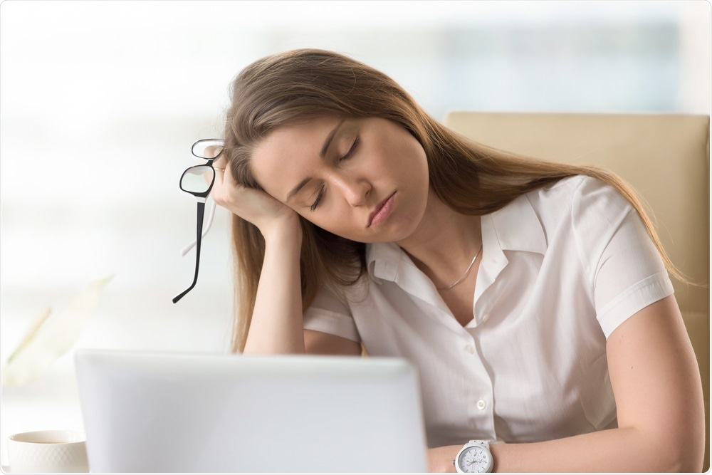 Woman sleeping during the day at her desk