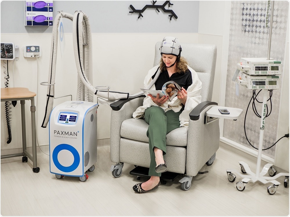 Woman using the PAXMAN scalp cooling system