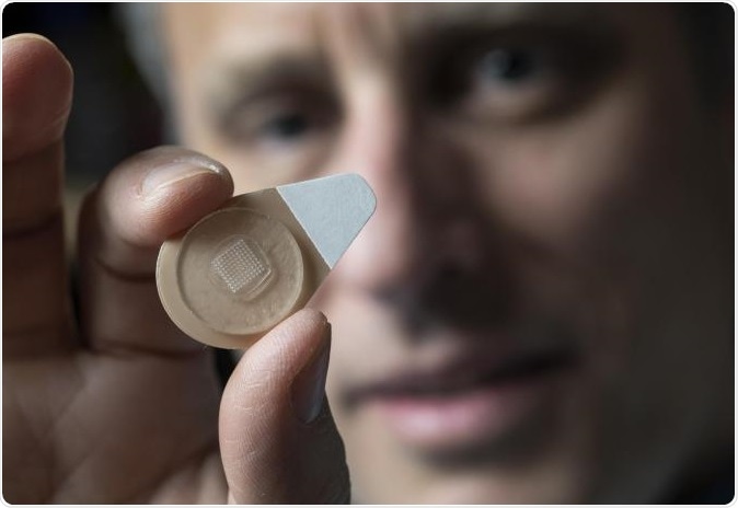 Regents Professor Mark Prausnitz holds an experimental microneedle contraceptive skin patch. Designed to be self-administered by women for long-acting contraception, the patch could provide a new family planning option. (Credit: Christopher Moore, Georgia Tech)