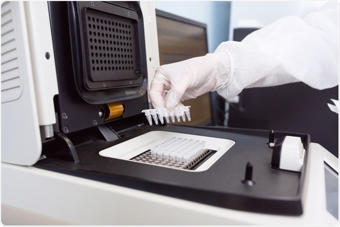 Geneticist placing strips with DNA into the PCR thermal cycler - Image Credit: UvGroup / Shutterstock
