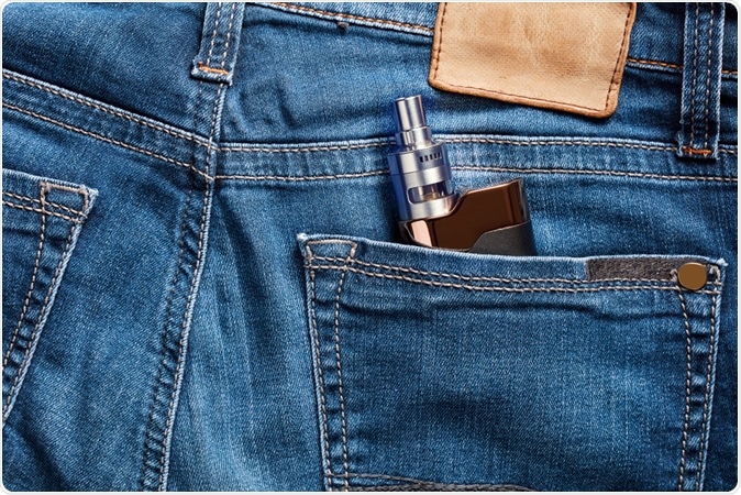 Electronic cigarette in the back pocket of a blue jean. Image Credit: Cagkan Sayin / Shutterstock
