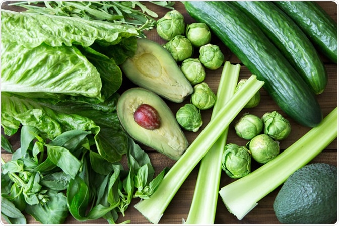 Food containing folic acid - Celery, arugula, avocado, Brussels sprouts, basil, cucumber romaine salad. Image Credit: Komarina / Shutterstock