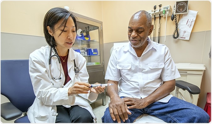 Dr. Mary Rhee, a physician-researcher with the Atlanta VA and Emory University, discusses the use of a glucometer with VA patient Joseph Fields. (Photo by Lisa Pessin)