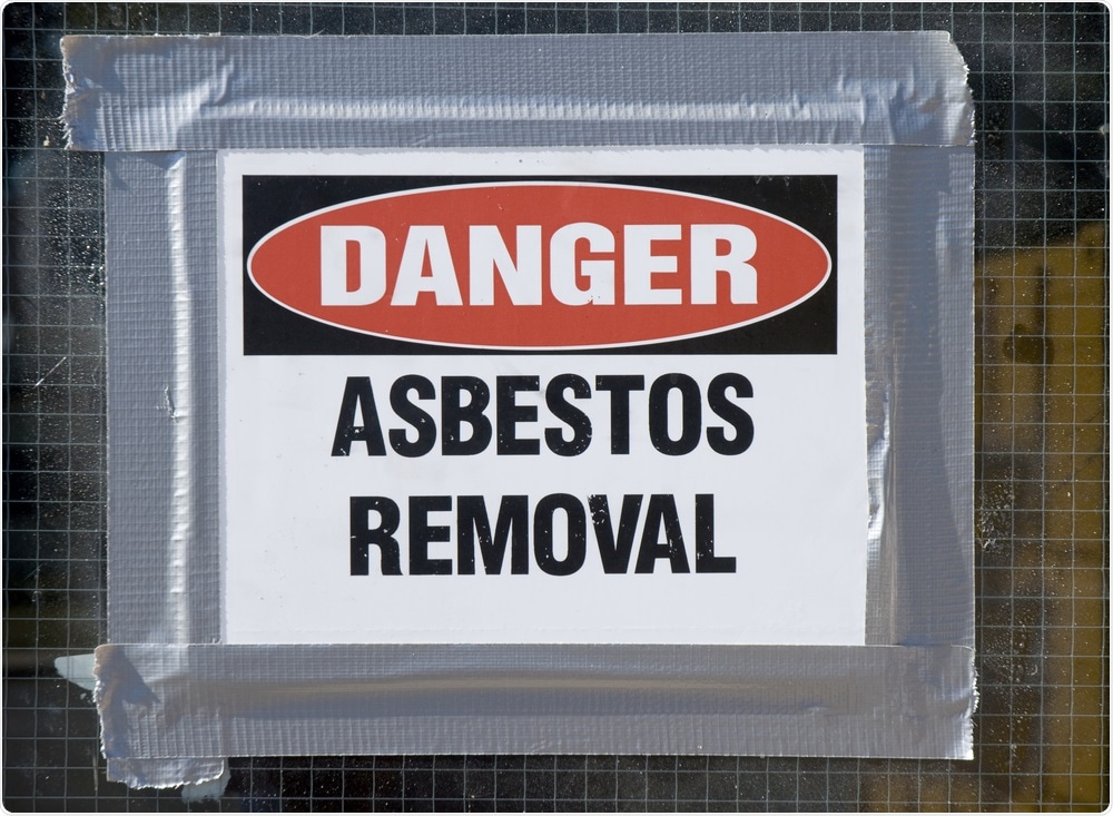 Asbestos removal sign on school door.