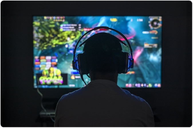 Young gamer playing video games. Image Credit: Sezer66 / Shutterstock