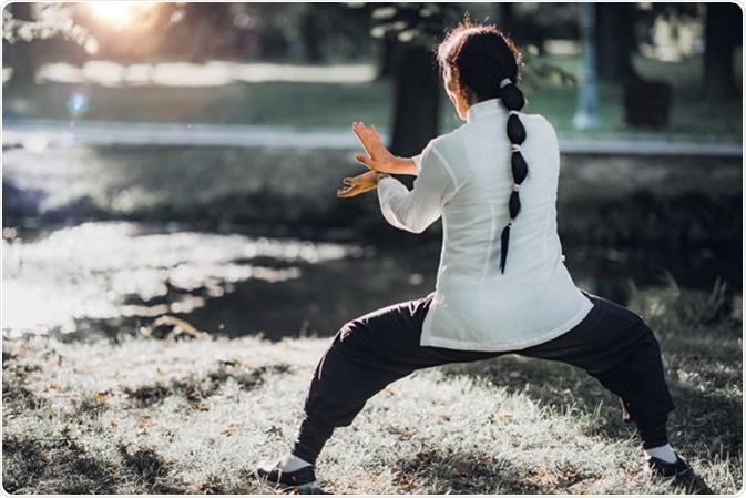 Woman practicing Tai Chi Quan in the park Credit: Microgen / Shutterstock