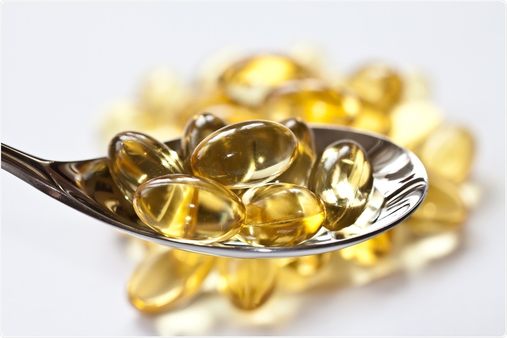 Vitamin D supplements on a spoon