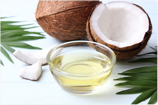 Coconuts and coconut oil. White bear studio / Shutterstock