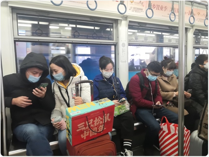 Chongqing, China-Jan, 23th 2020: Chinese citizens wearing breathing masks to protect from 2019-nCoV disease. Helloabc / Shutterstock