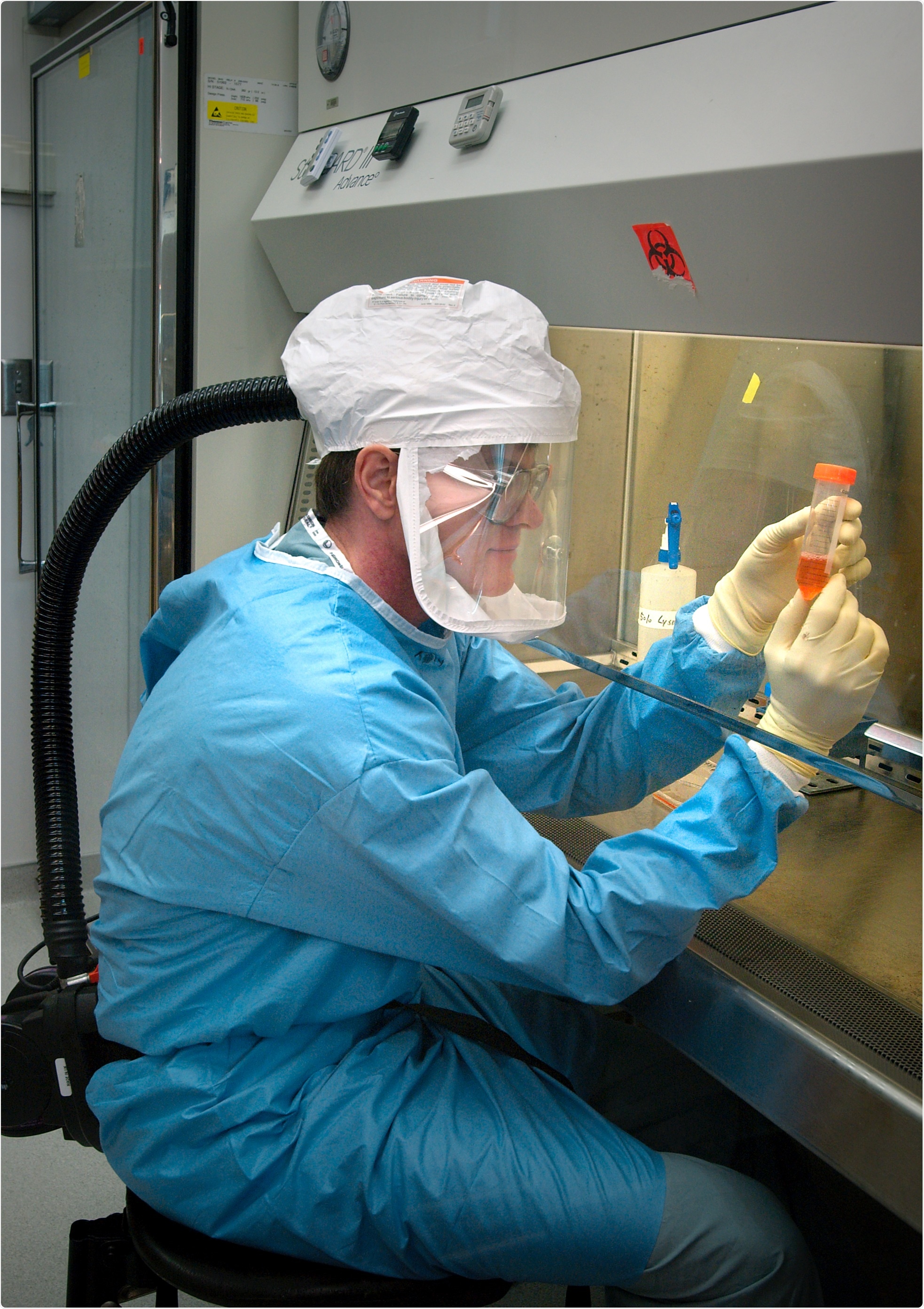 Researcher at US Centers for Disease Control, Atlanta, Georgia, working with influenza virus under biosafety level 3 conditions, with respirator inside a biosafety cabinet (BSC). Photo Credit: James Gathany Content Providers(s): CDC