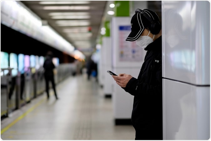 Shanghai/China-Jan.2020: COVID-19, man wearing surgical mask at railway station platform in Shanghai. Image Credit: Robert Wei / Shutterstock