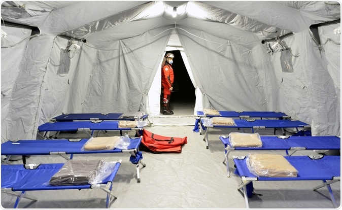 LOMBARDIA, ITALY - FEBRUARY 26, 2020: Empty hospital field tent for patients with coronavirus. Image Credit: Faboi / Shutterstock