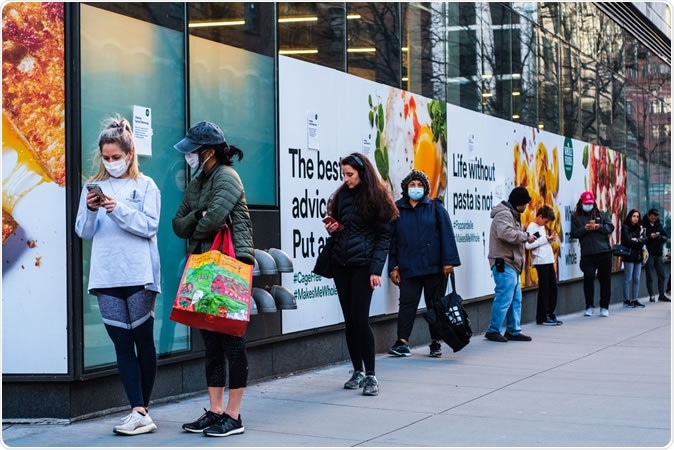 NEW YORK - APRIL 01, 2020: A long line outside of Whole Foods in Tribeca, New York as the store has implemented social distancing measures during the COVID-19 pandemic. Image Credit: Jennifer M. Mason / Shutterstock