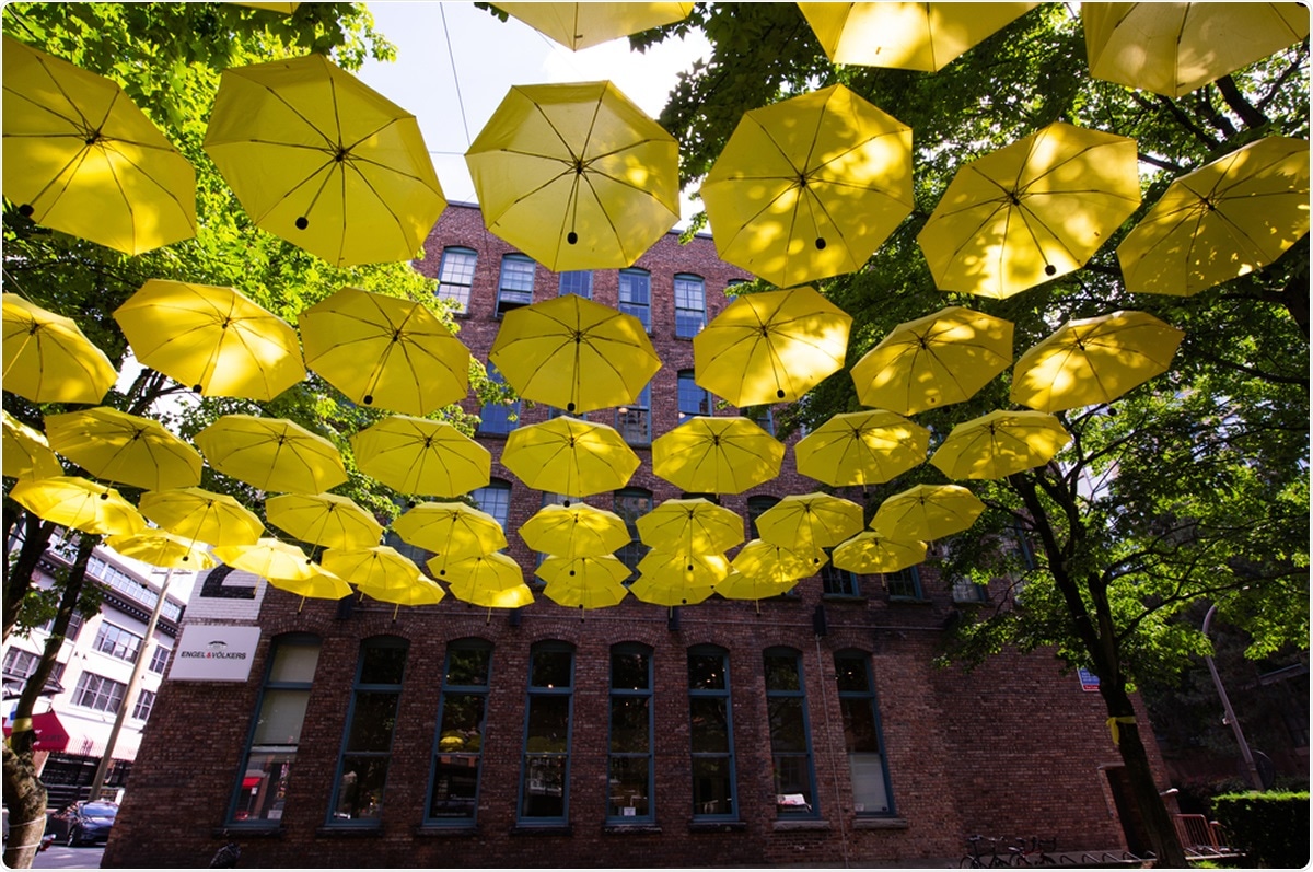 June 17,2020 Vancouver British Columbia Canada Yellow umbrellas in Yaletown will cover the square as a commitment to flattening the curve the fight against COVID-19. Image Credit: FPfotografy / Shutterstock