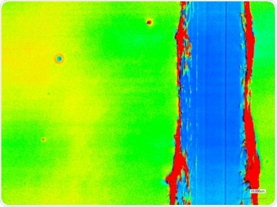 Top: Two types of coverslips spin-coated with PBS-DLS 50:50 copolyester (1.5 wt.% solution in THF, 4000 rpm) Bottom: Laser scanning micrograph of a scratch test of the coating on round coverslip confirming ~100 nm thickness and Ra ~10 nm.