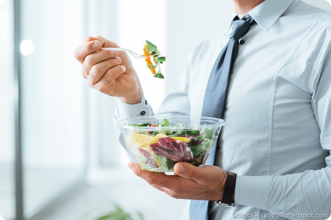 Businessman eating salad healthy