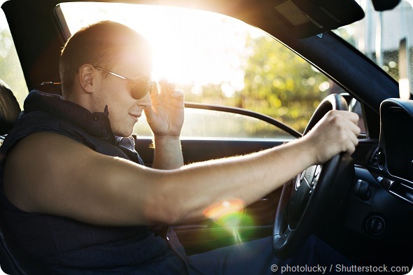 Guy in sunglasses driving car