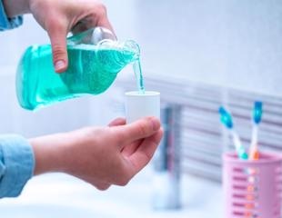 Surfactant-containing oral mouthwashes target the lipid envelope of SARS-CoV-2