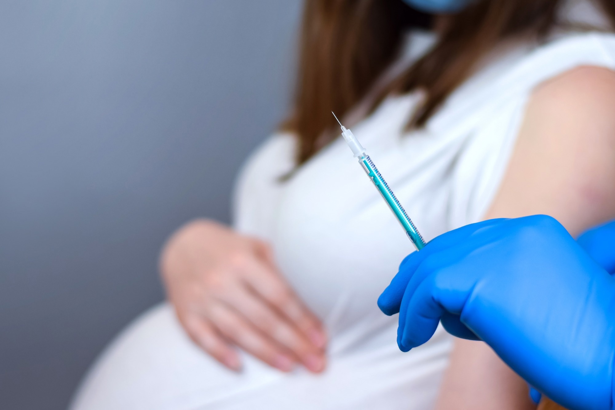 Study: COVID-19 Booster Vaccination in Early Pregnancy and Surveillance for Spontaneous Abortion. Image Credit: MarinaDemidiuk/Shutterstock.com