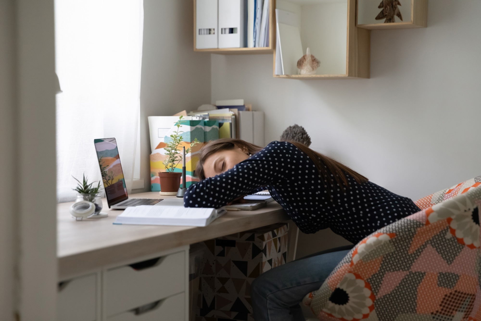 Tired woman asleep at her desk