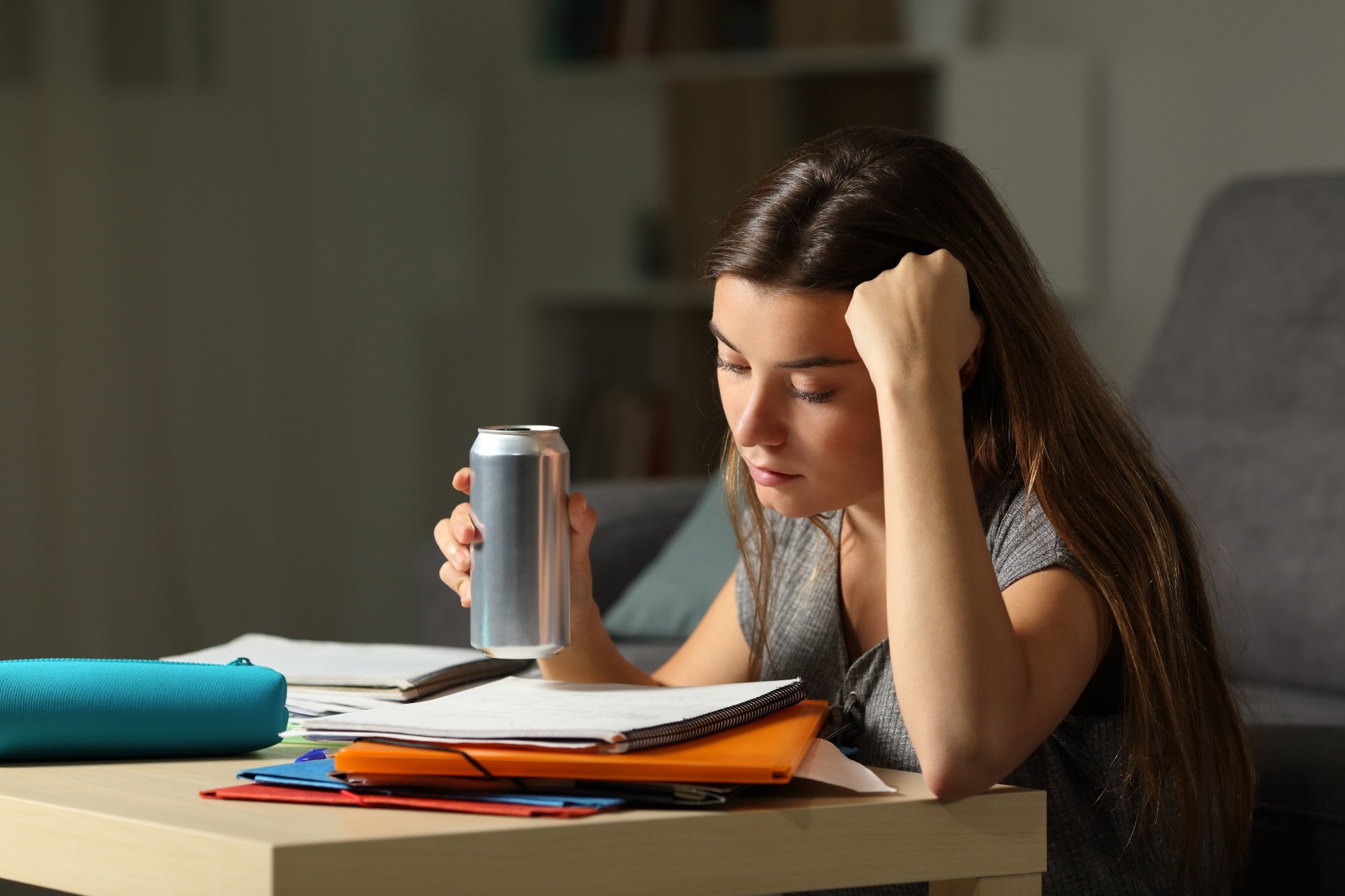 Students are studying and drinking an energy drink